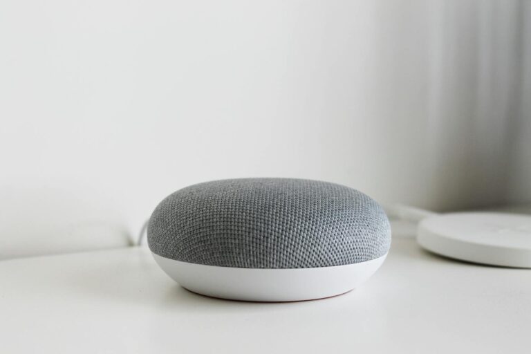 A sleek and modern smart speaker on a clean white surface, perfect for tech-inspired decor.